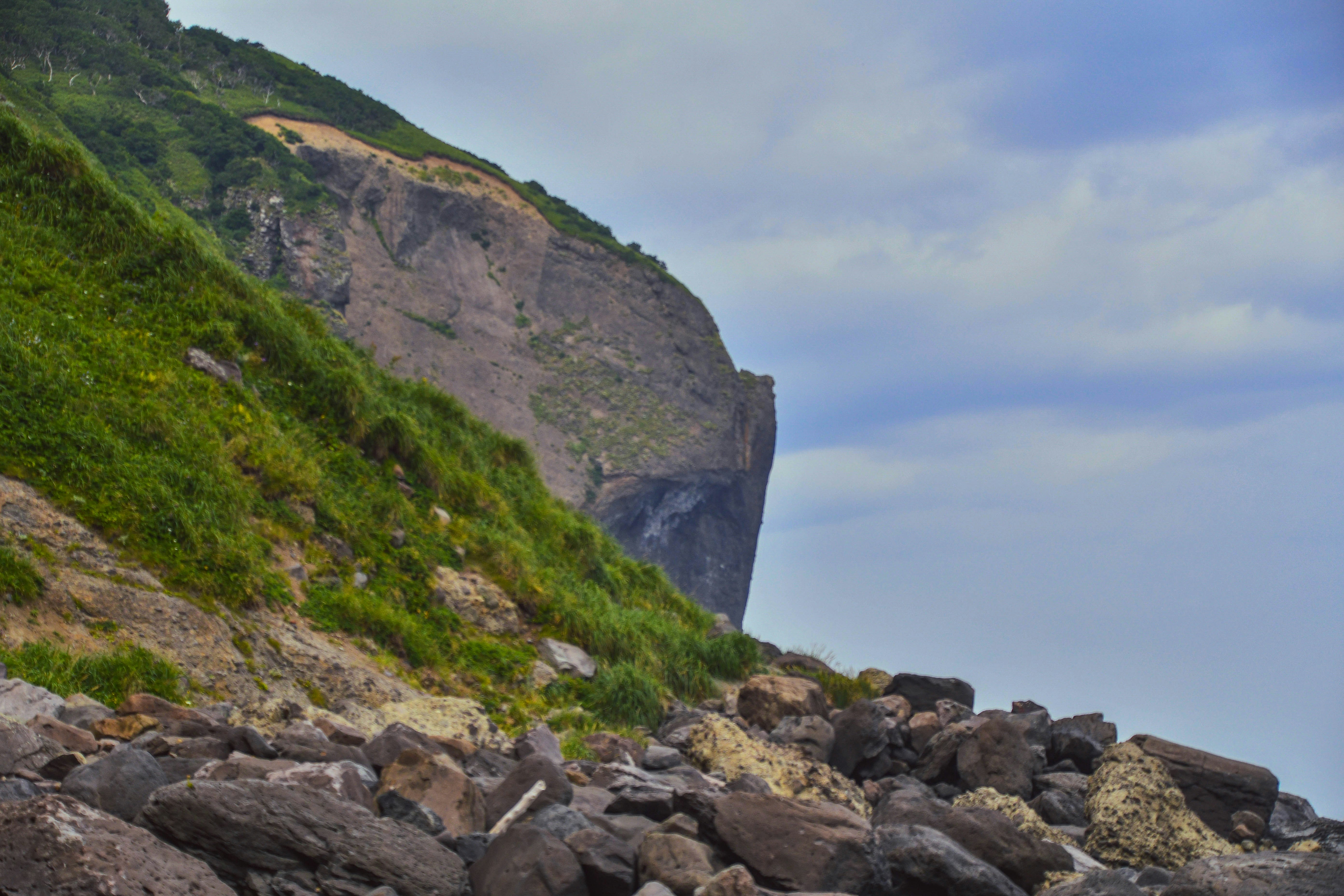 a rocky beach with a mountain in the background