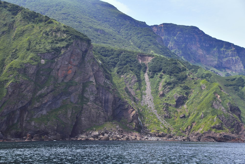 a mountain side with a river running through it