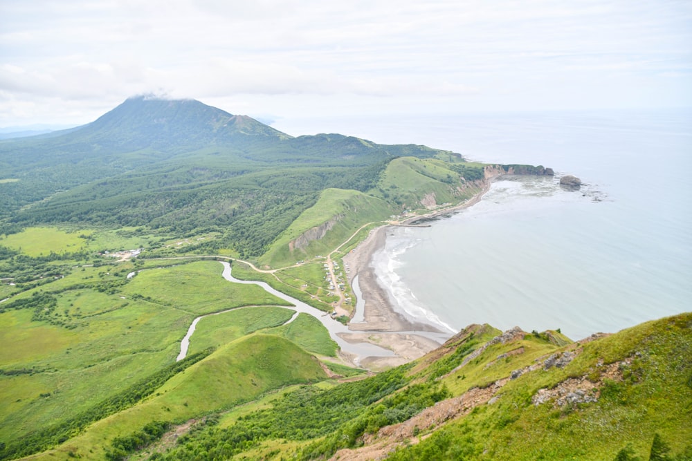 a scenic view of a beach and a mountain