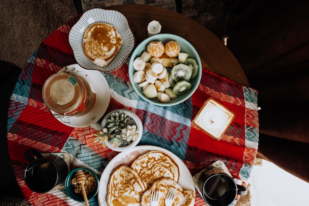 a table topped with plates of food and drinks