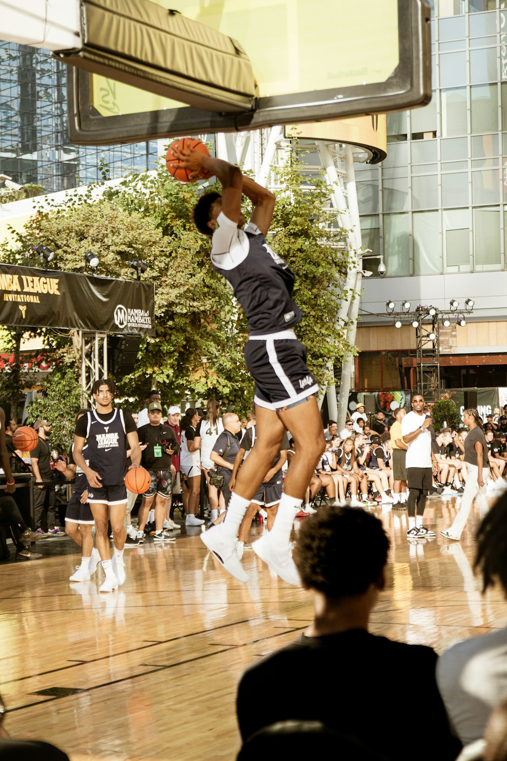 a man jumping up into the air to dunk a basketball