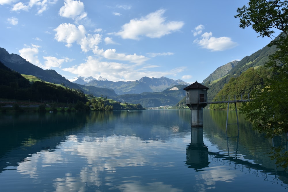 a lake with a clock tower in the middle of it