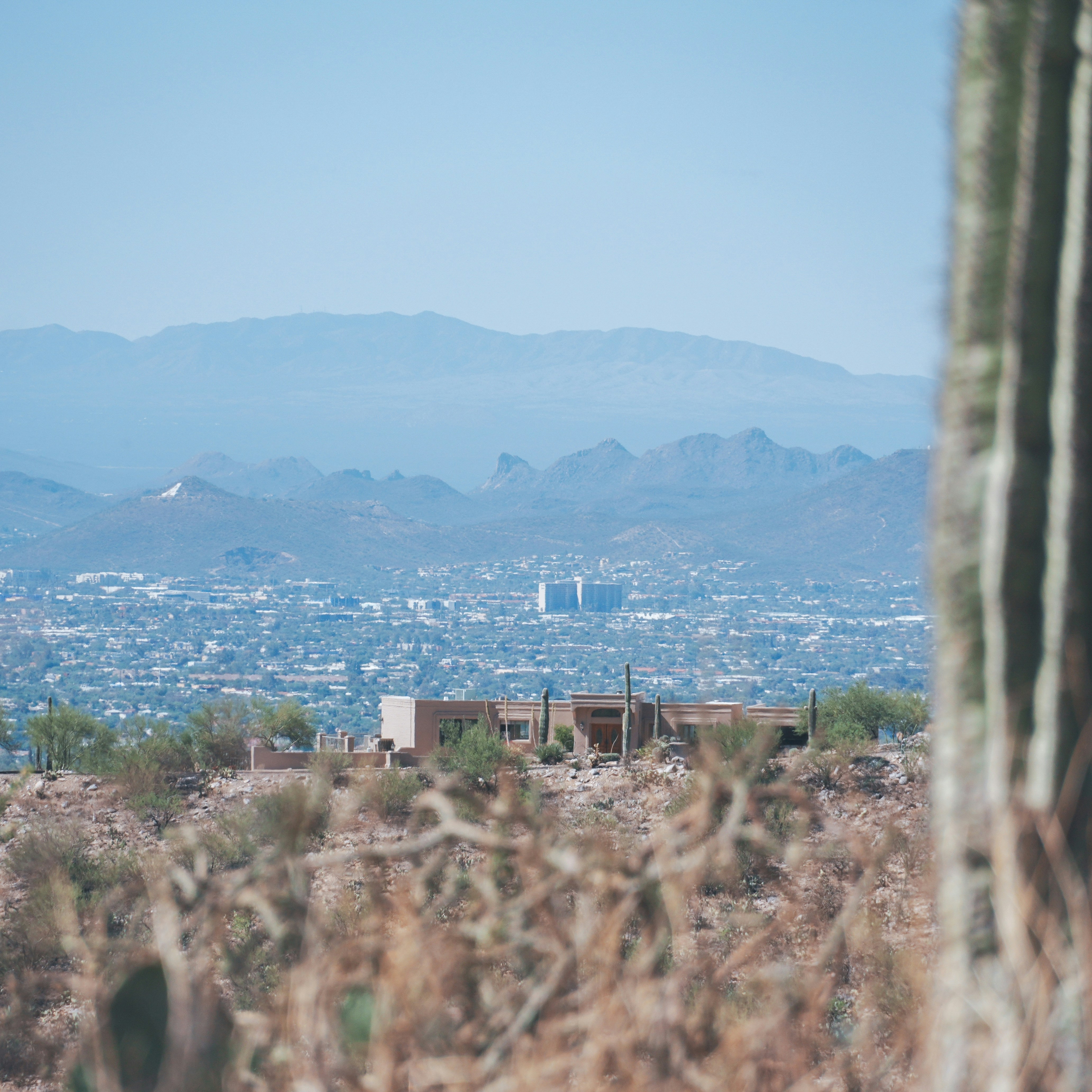 a view of a city from a distance with mountains in the background