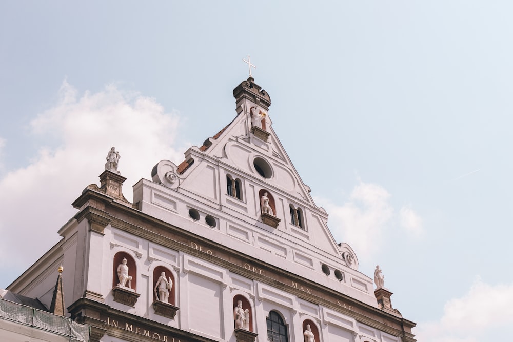 a tall white building with a clock on the top of it