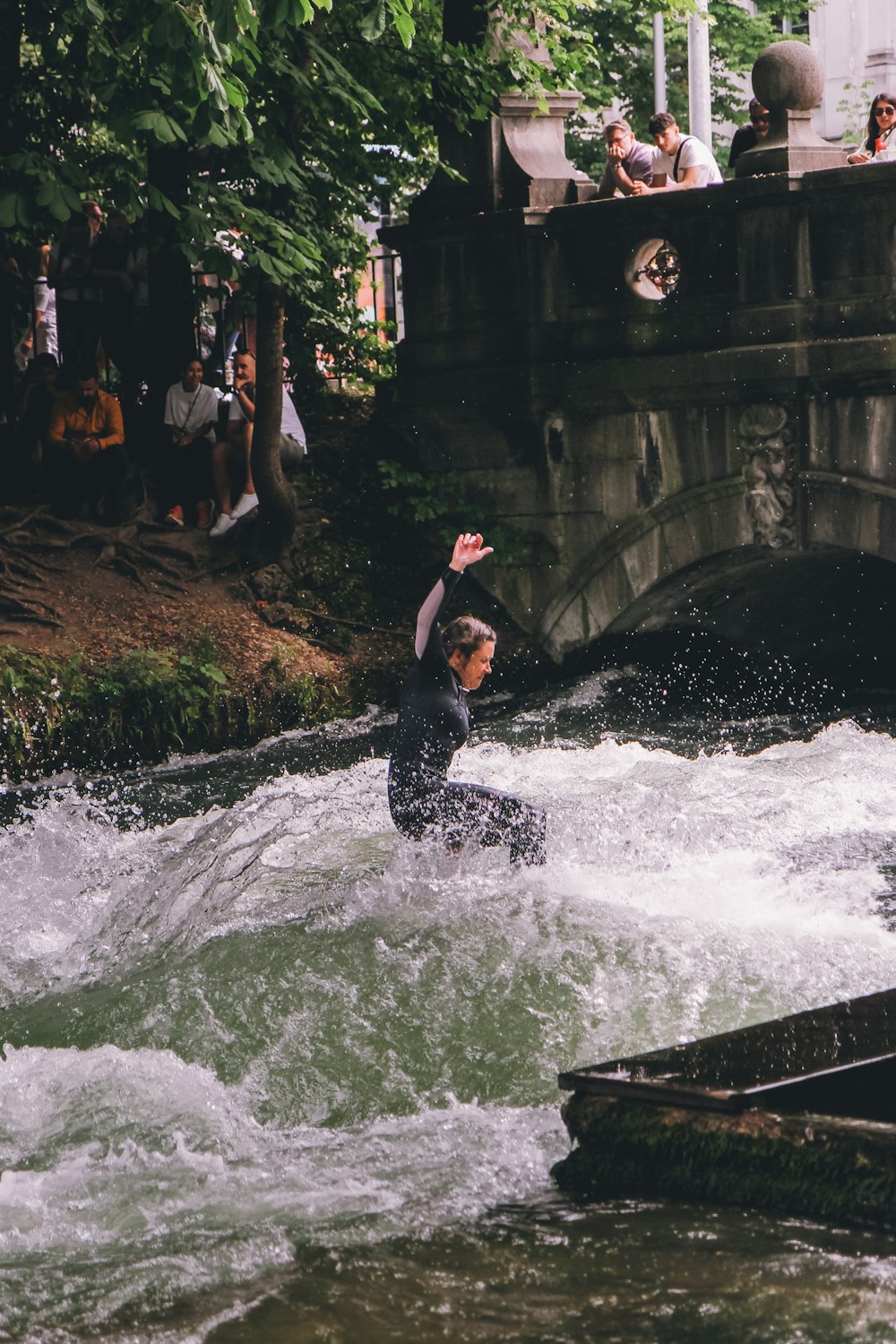 a man riding a wave on top of a river