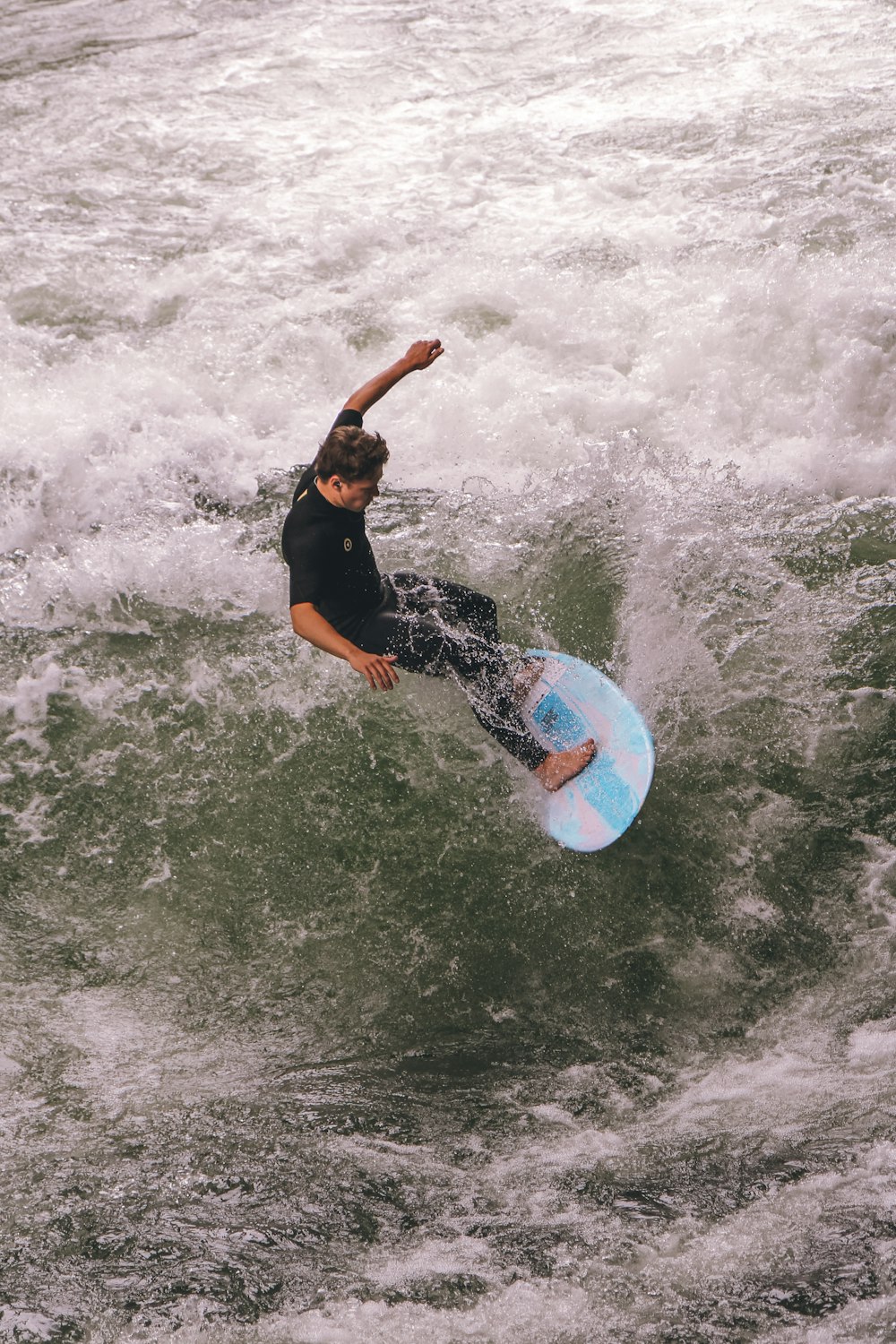 a man riding a wave on top of a surfboard