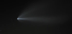 Starry night sky with a mysterious glowing object moving across