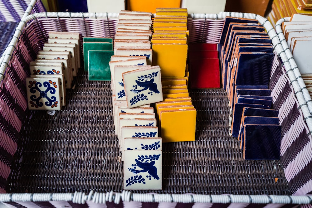 a basket filled with lots of different colored plates