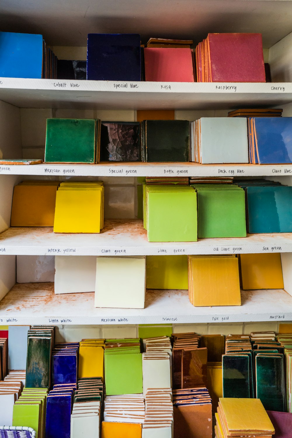 a shelf filled with lots of different colored boxes