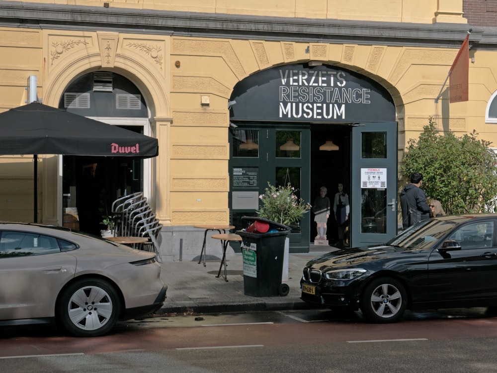 a couple of cars parked in front of a building