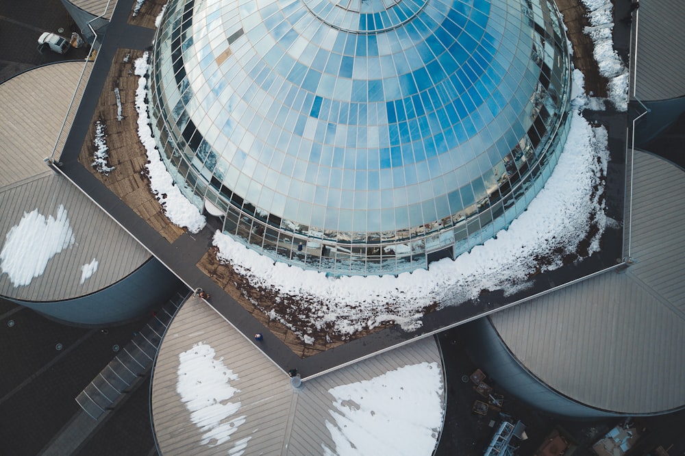 an aerial view of a building with snow on the ground