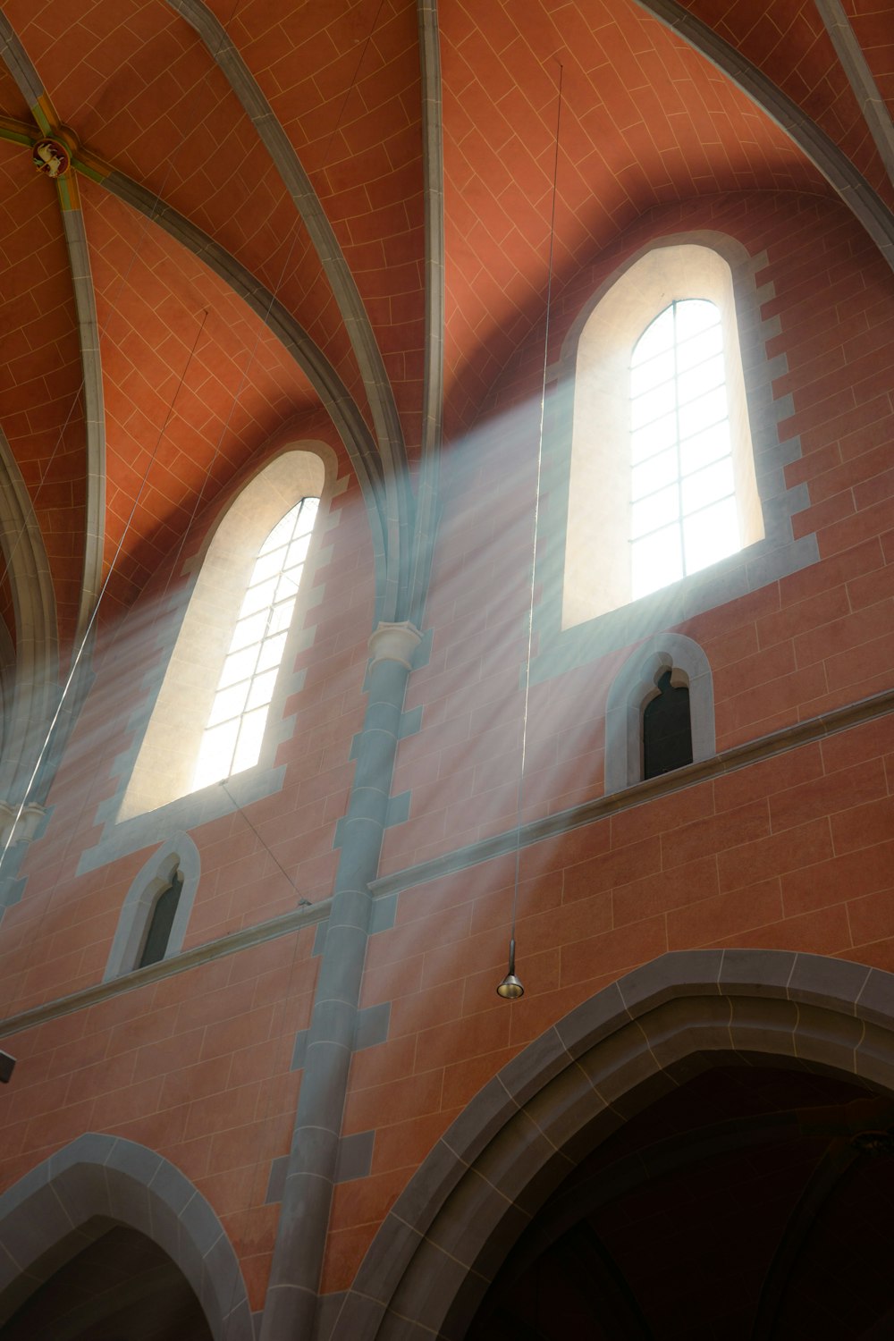 sunlight streaming through two windows in a building