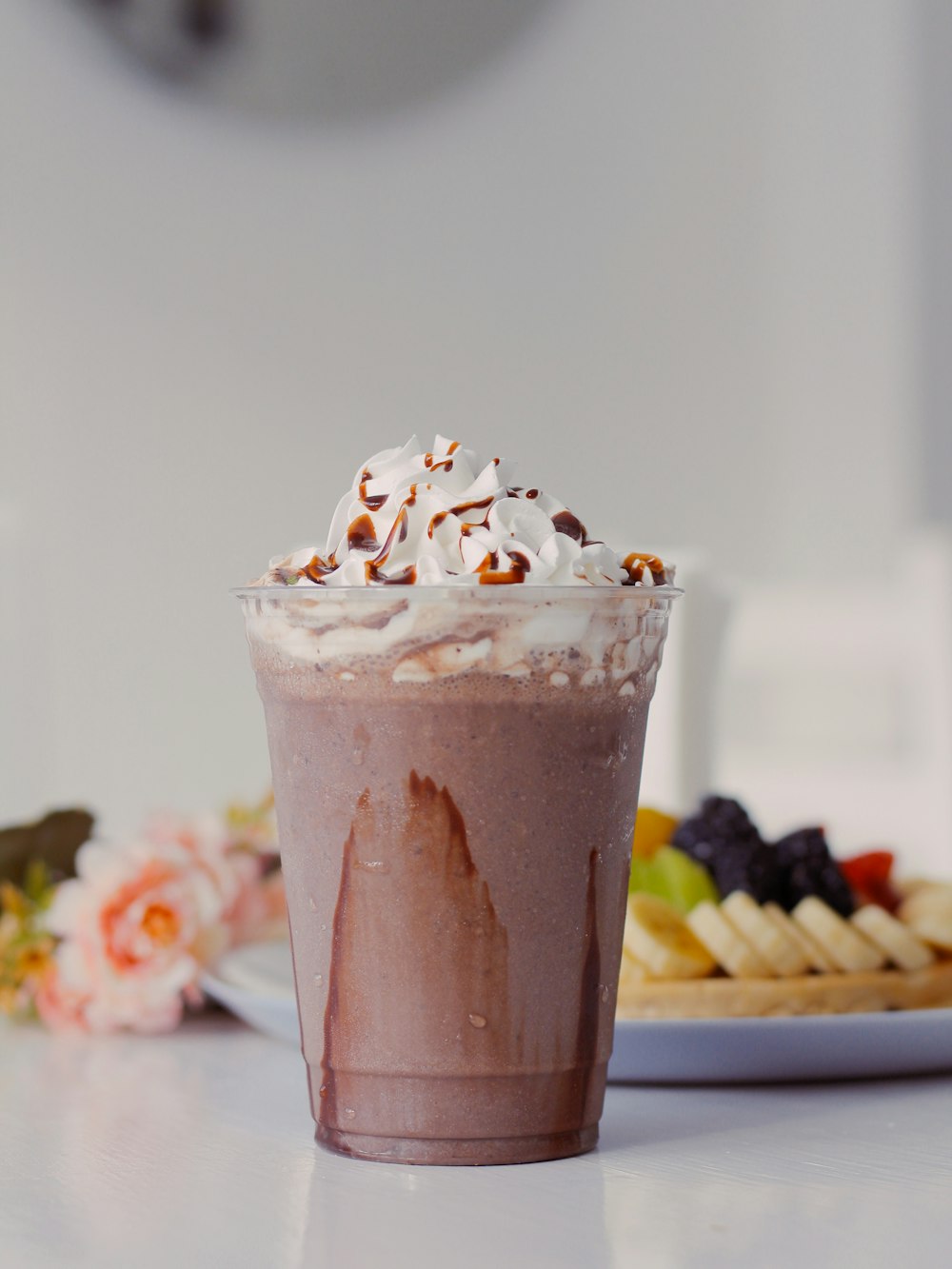 a cup of chocolate milkshake with whipped cream on top