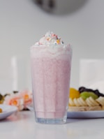 Refreshing thick milkshakes topped with whipped cream and fresh fruit slices.