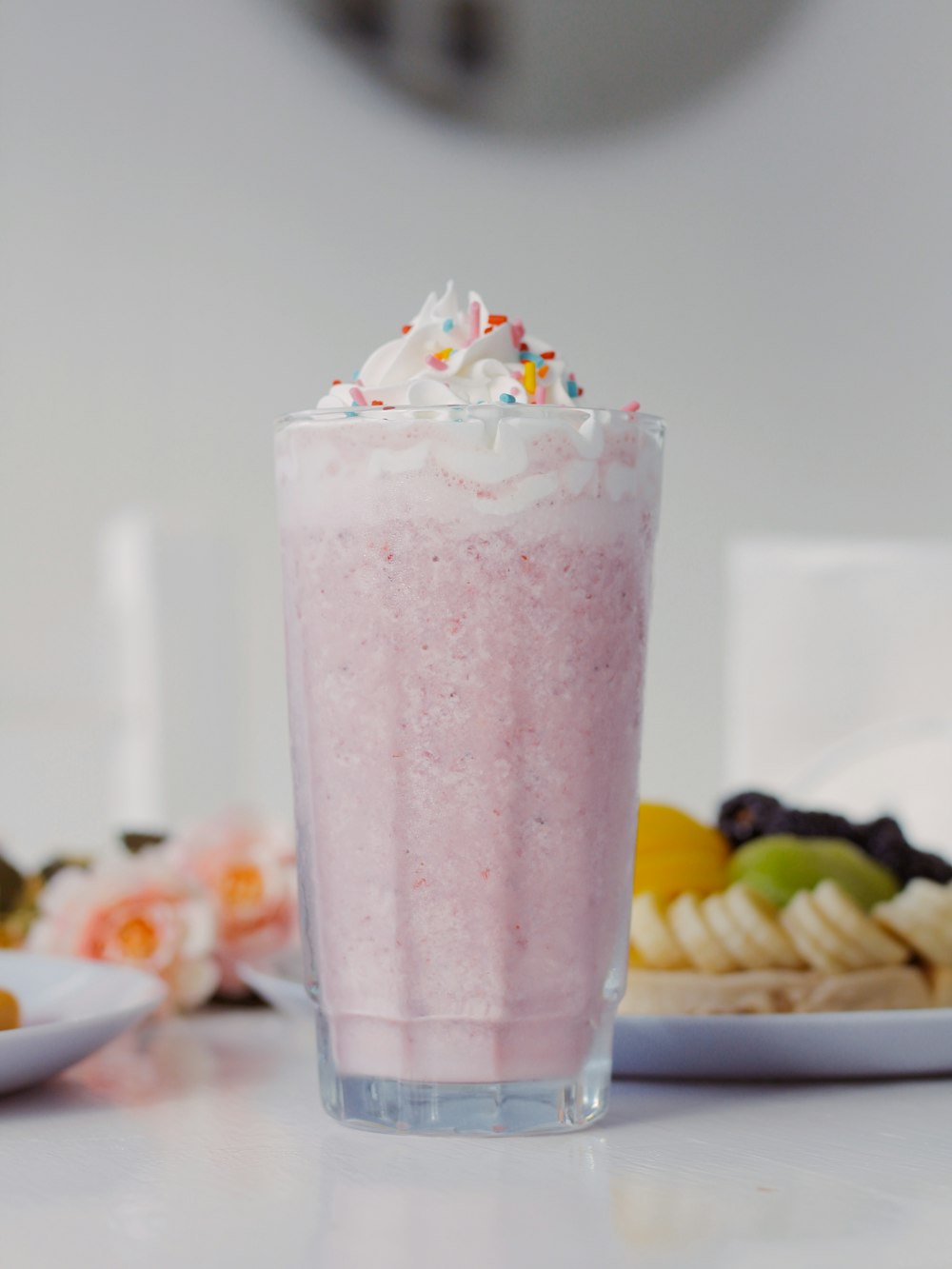 a pink drink sitting on top of a table