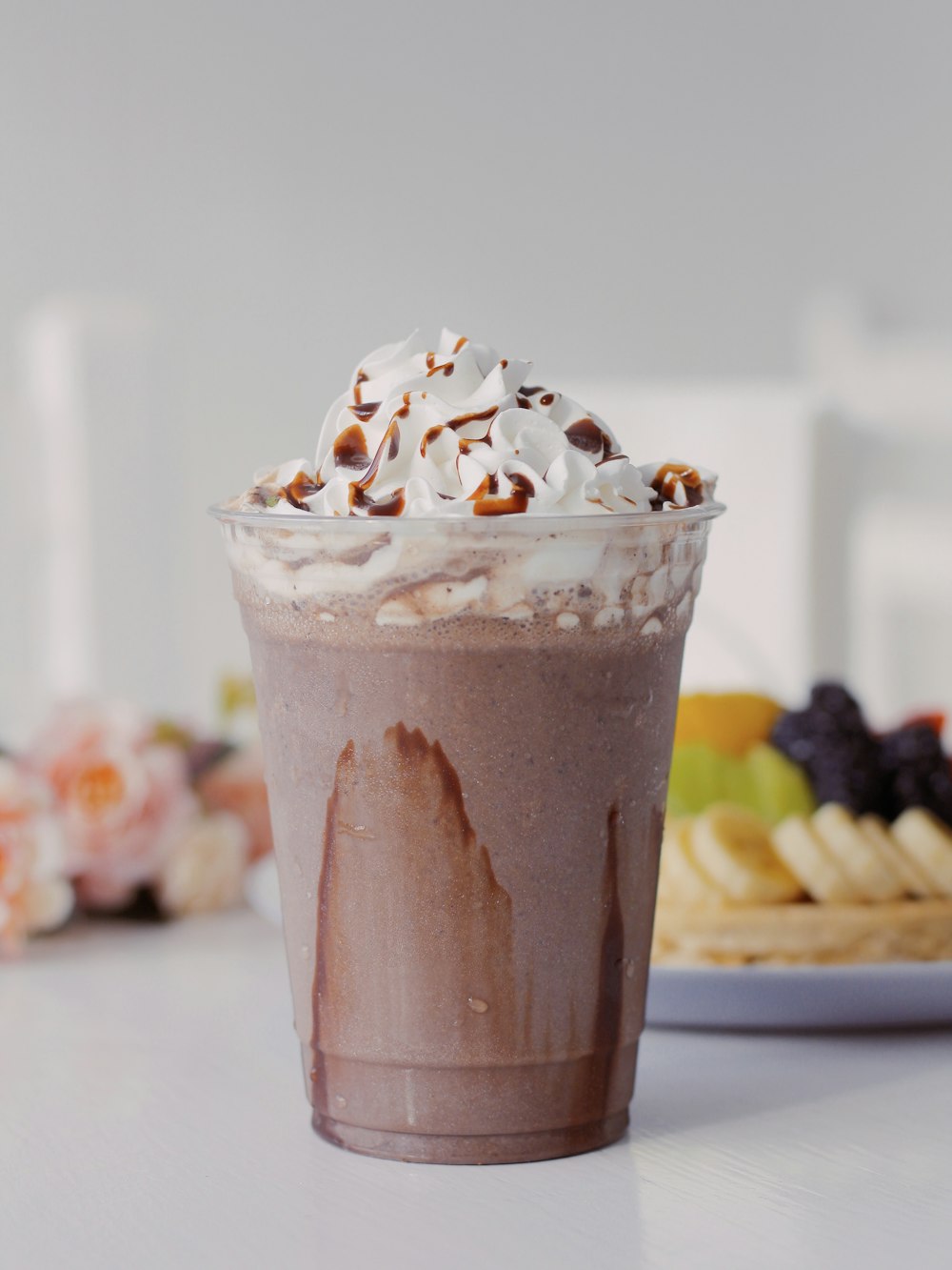 a cup of chocolate milkshake with whipped cream on top
