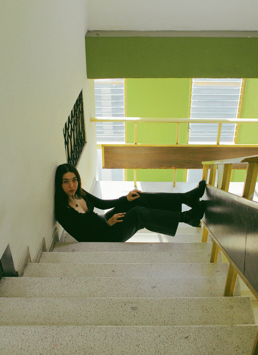 a woman sitting on the stairs of a building