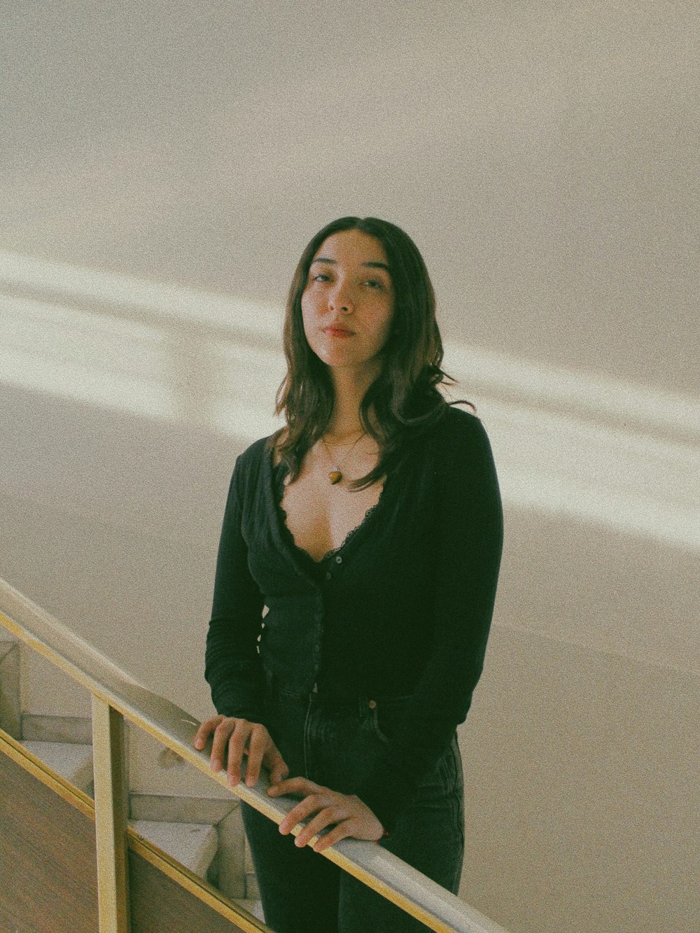 a woman standing at the top of a set of stairs