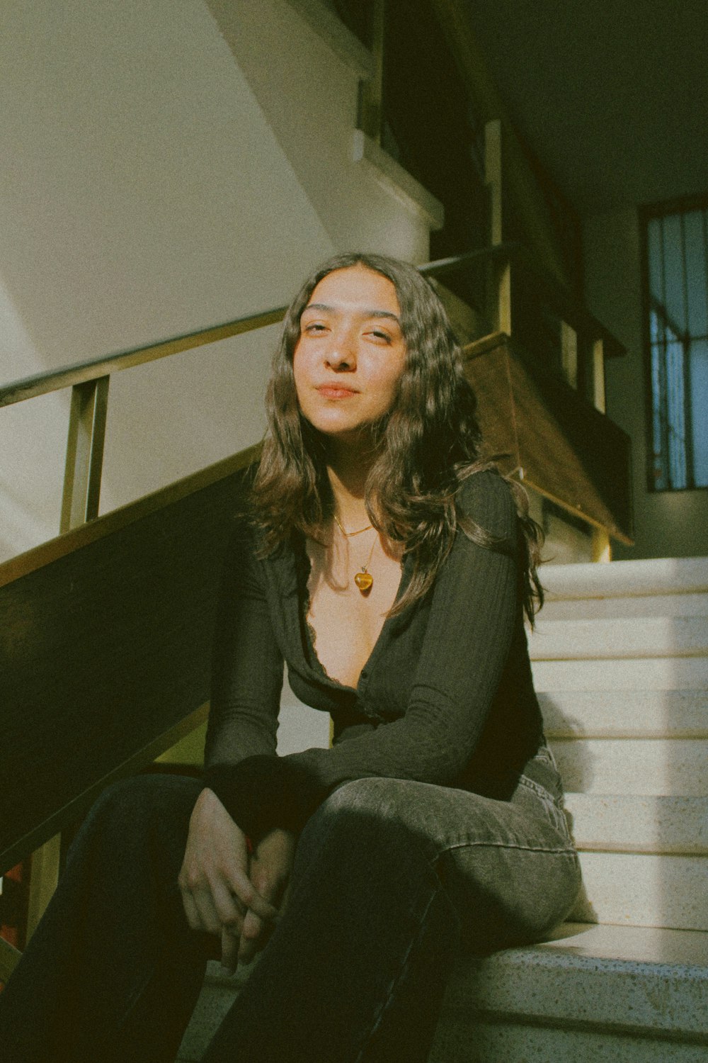 a woman sitting on the steps of a building