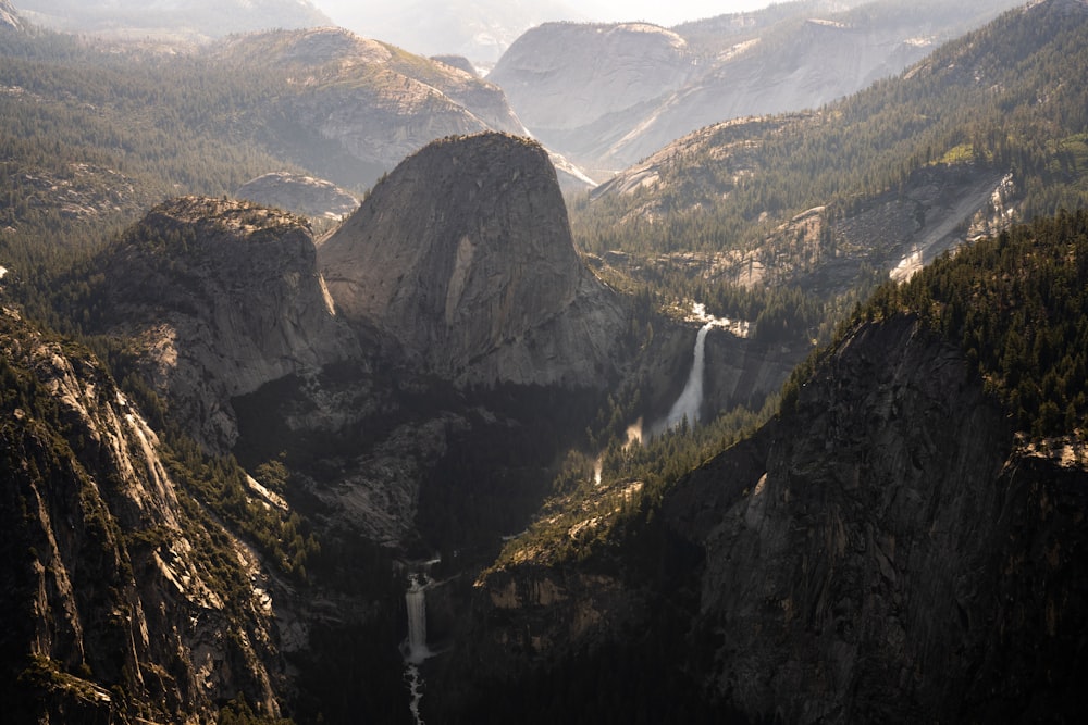 a mountain valley with a waterfall in the middle