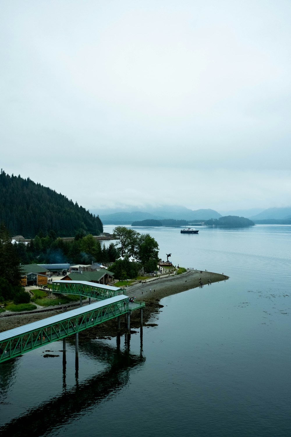 a green bridge over a body of water