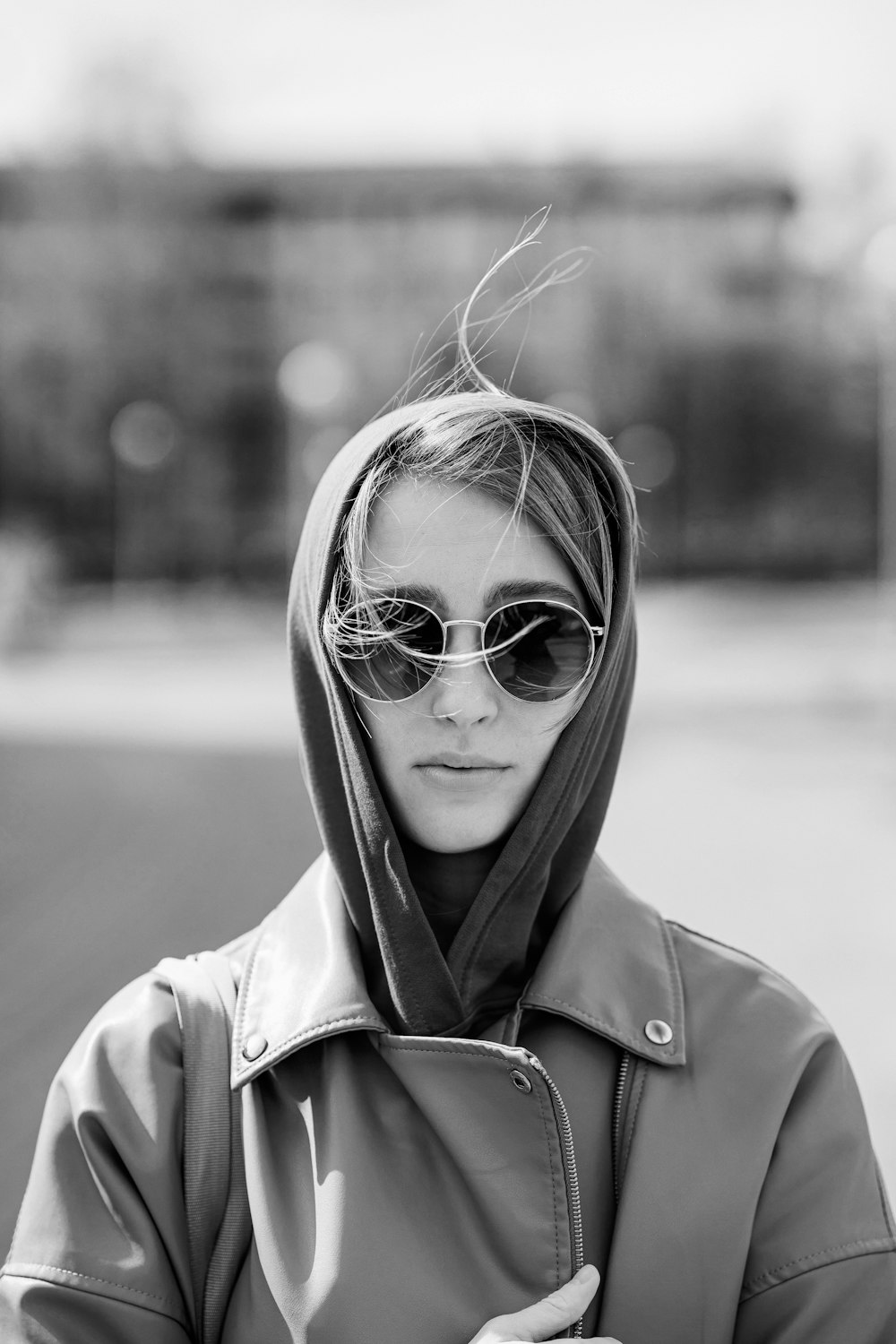 a woman wearing sunglasses and a jacket