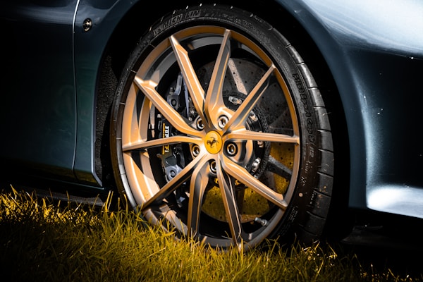 Close-up of a sleek imported alloy wheel shining under natural light