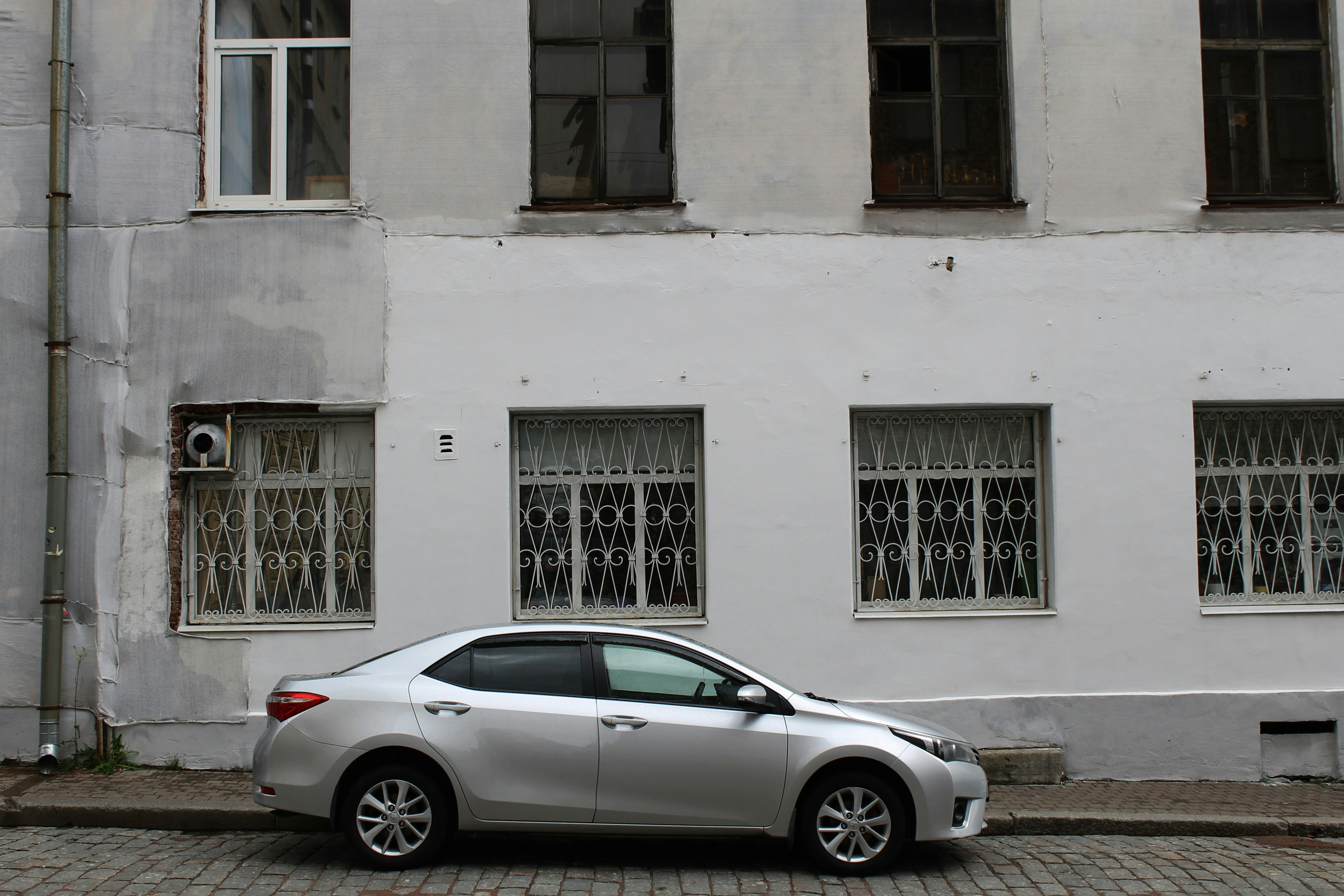 Compact affordable electric car parked at a public charging station in a city street