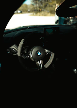A close-up of a learner driver attentively listening to instructions inside a car in Esslingen.