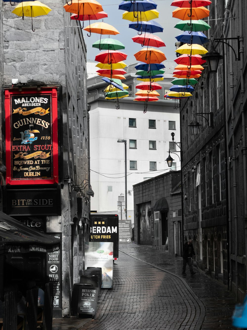 a city street with umbrellas hanging above it