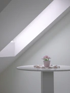 Minimalist tablescape featuring muted florals and natural textures under warm lighting.