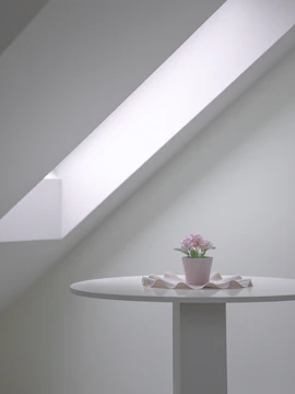 Minimalist tablescape featuring muted florals and natural textures under warm lighting.