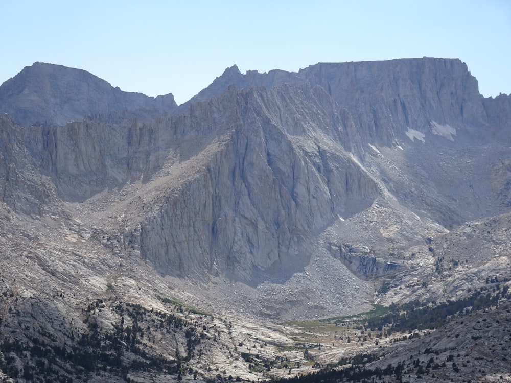 a view of a mountain range from the top of a hill