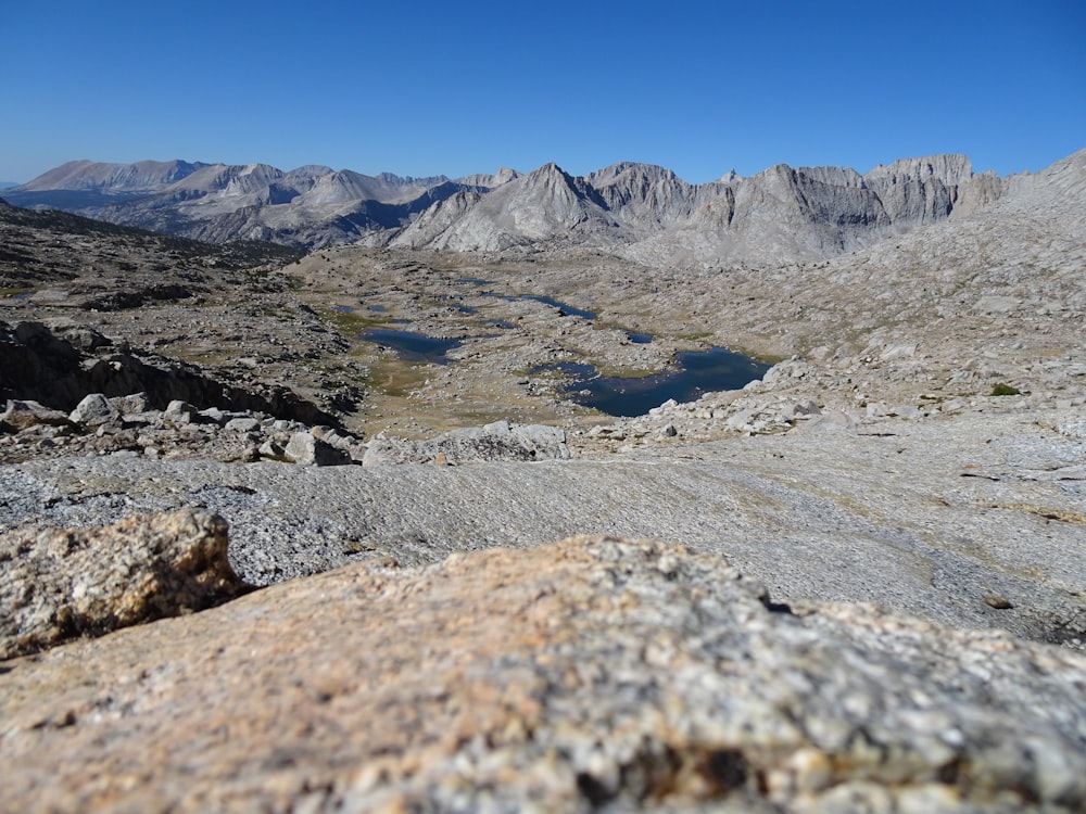 a view of a mountain range with a lake in the foreground