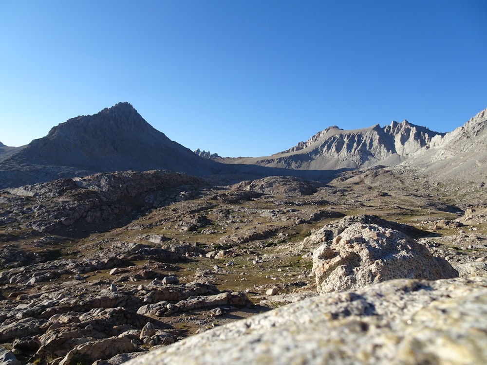 a view of a mountain range from the top of a hill