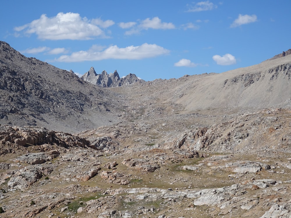 a view of a mountain range from a rocky area