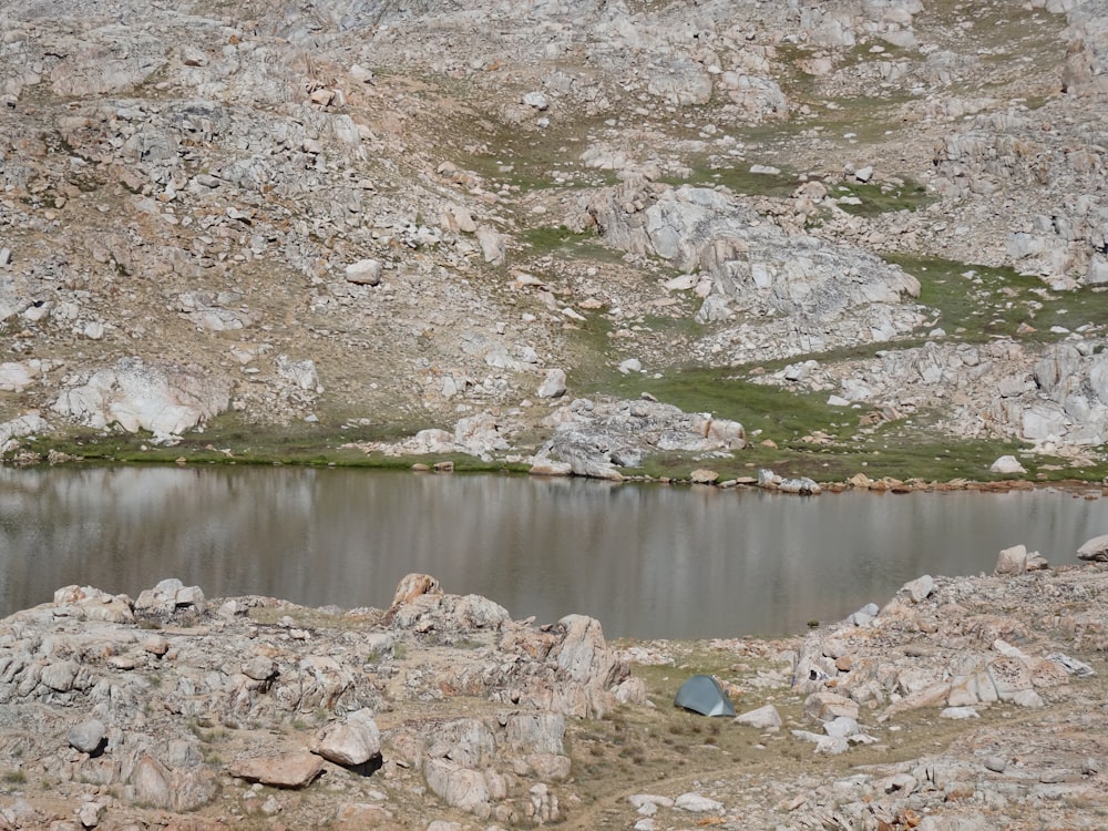 a small lake in the middle of a rocky area