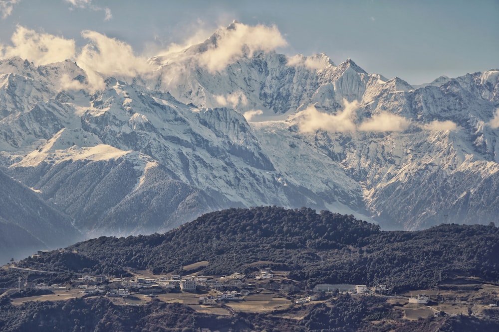 a view of a mountain range with houses in the foreground