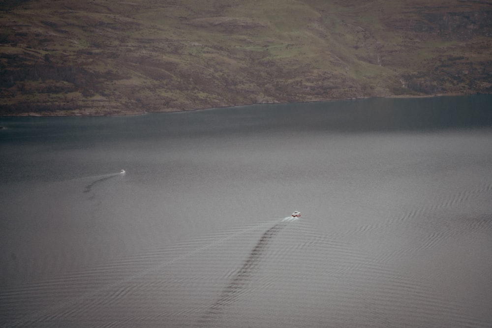 a lone boat in the middle of a large body of water