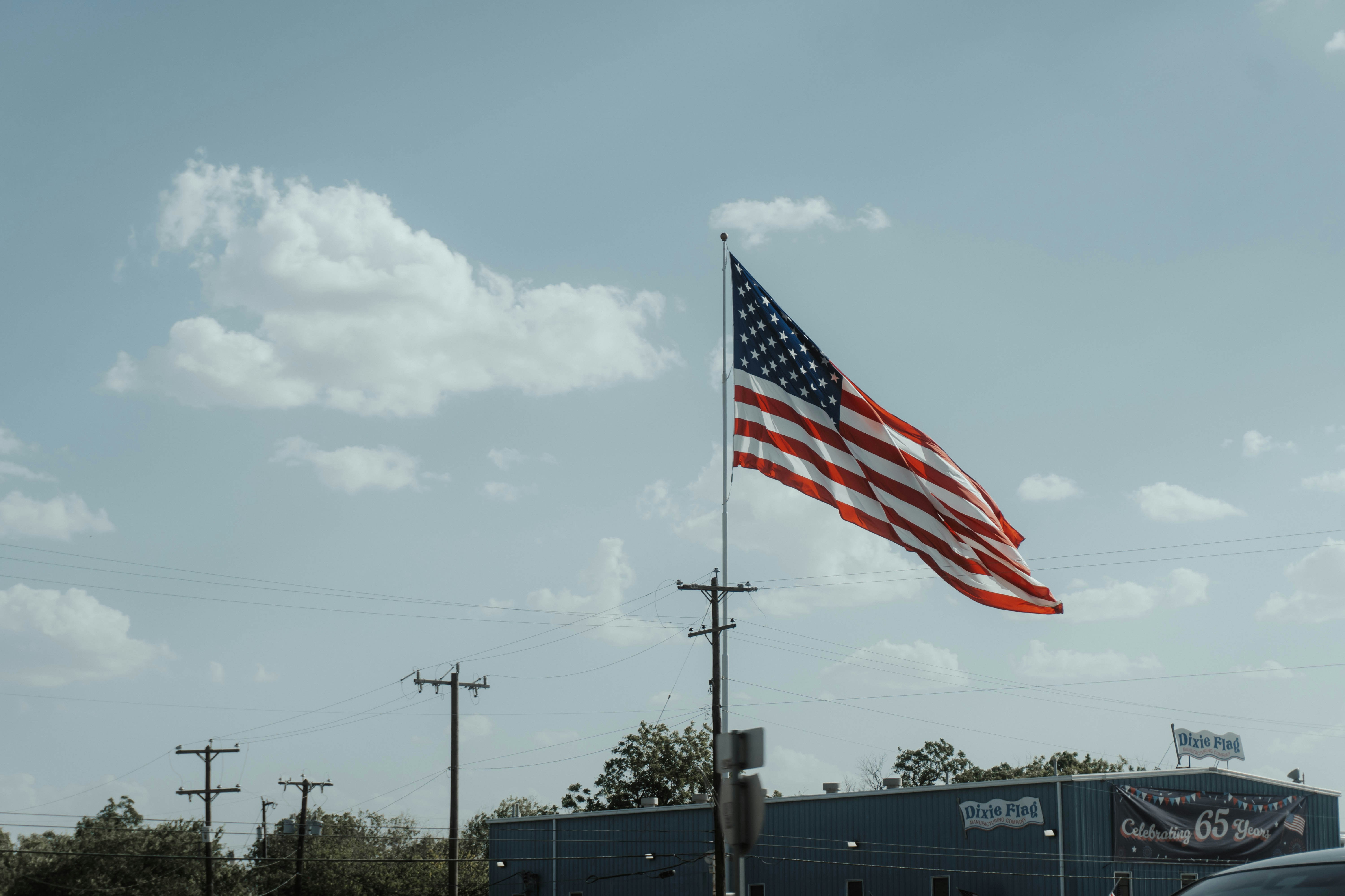 a large american flag flying in the air