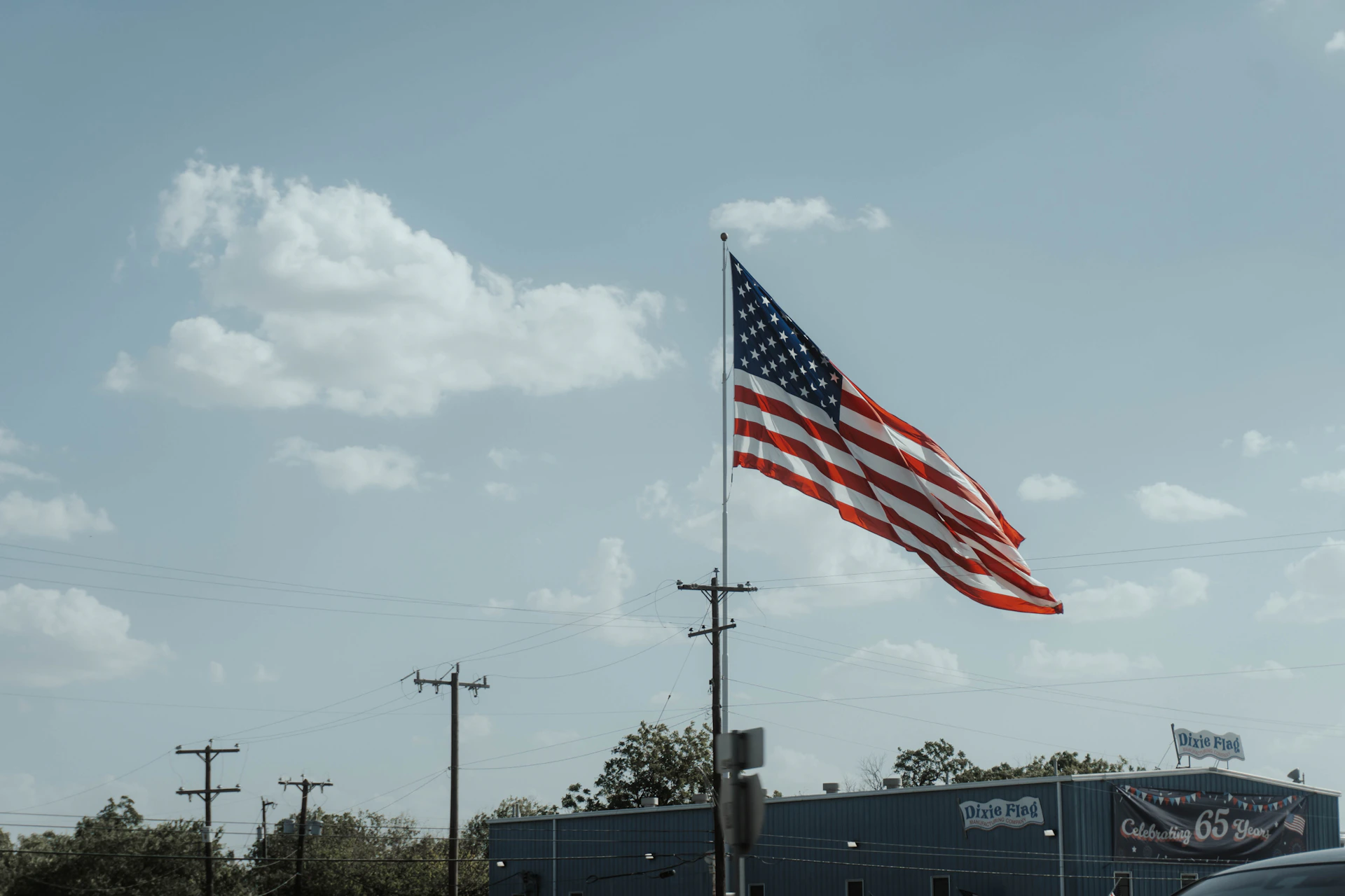 a large american flag flying in the air