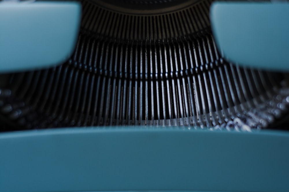 a close up of a typewriter with a clock in the background