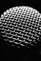 Detailed shot of AirPods speaker mesh showing fine craftsmanship.