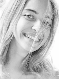 Close-up portrait of Gigi Escobar with a confident and warm expression.