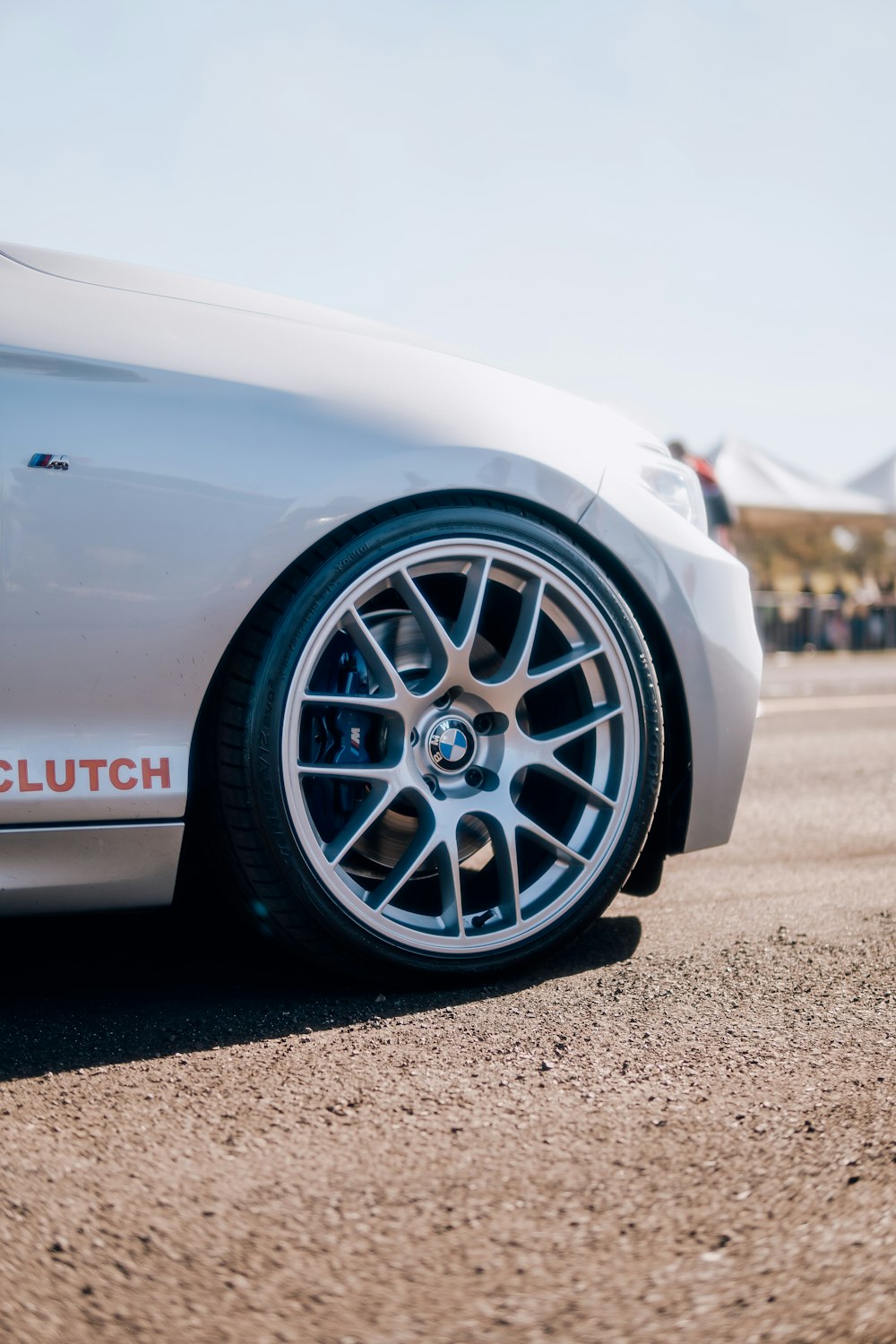 a close up of a white sports car on a road