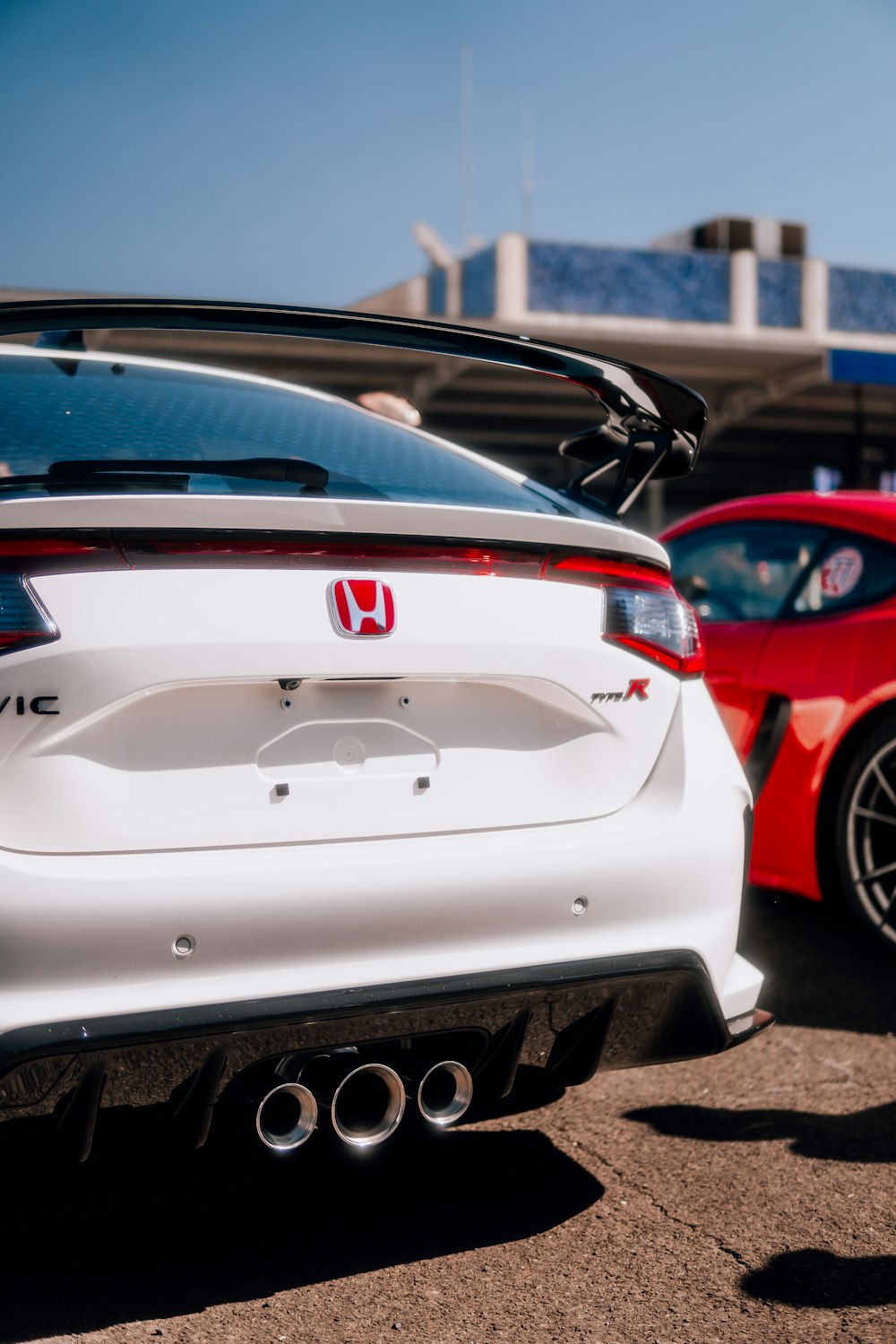 a white sports car parked in a parking lot