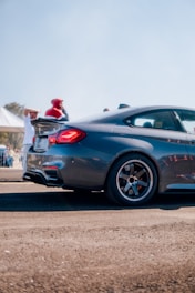 A sleek, shiny new car parked in front of the Superior Motors showroom on a sunny day.