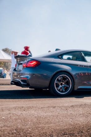 A sleek, shiny new car parked in front of the Superior Motors showroom on a sunny day.