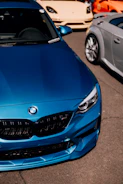 a blue car parked next to a silver car
