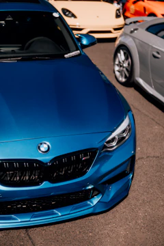a blue car parked next to a silver car